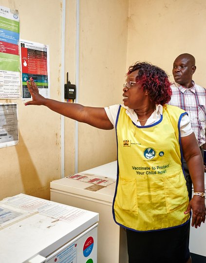 Victorine Wasonga (center) reviews with Fata Acquoi (right) the vaccine contingency plan at Chuowe Health Centre.