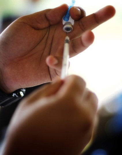 Hands holding a vaccine