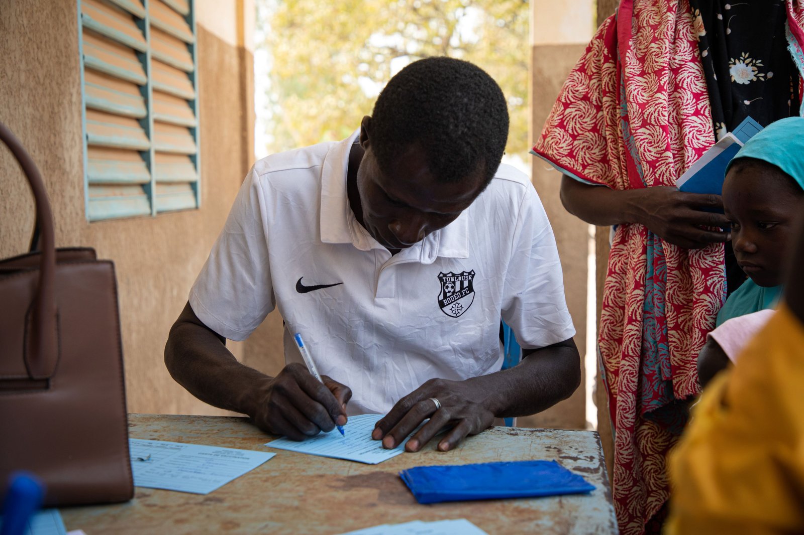 Photo: A health care worker fills out vaccination cards during Burkina Faso’s TCV introduction in 2025. Credit: TyVAC/Build Africa Communications